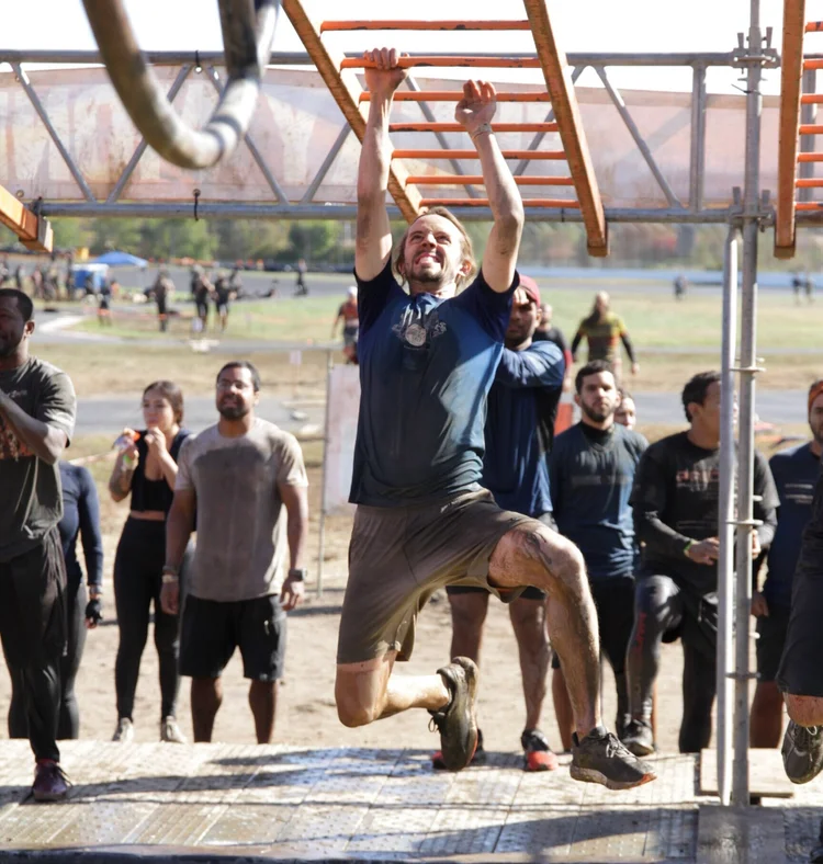 Jackson completing a muddy obstacle run